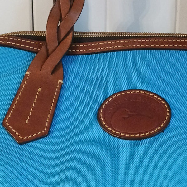 Dooney & Bourke Blue Canvas Tote With Leather Handles.